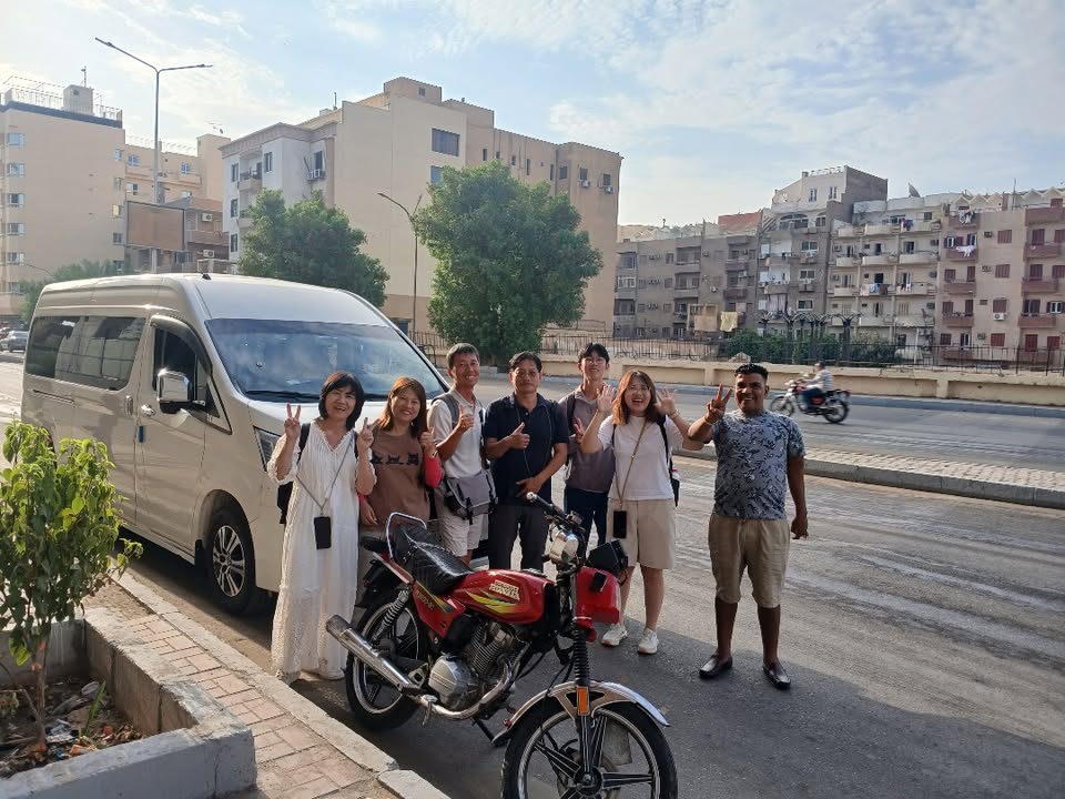 Ziki and guests beside the private tour van